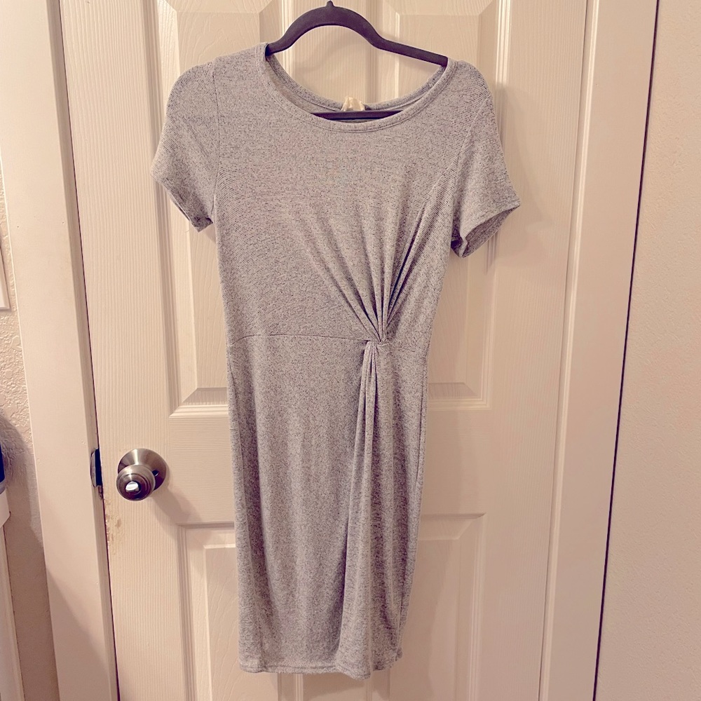 Grey mini dress cinched at the waist.